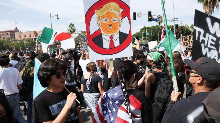 People hold Mexican flags during a No Kings Day protest against Trump's policies in LA. Pic: Reuters