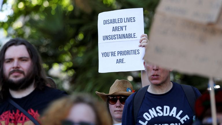 People from the disability rights group, Disabled People Against Cutss  hold a protest in Parliament Square.
Pic: Reuters