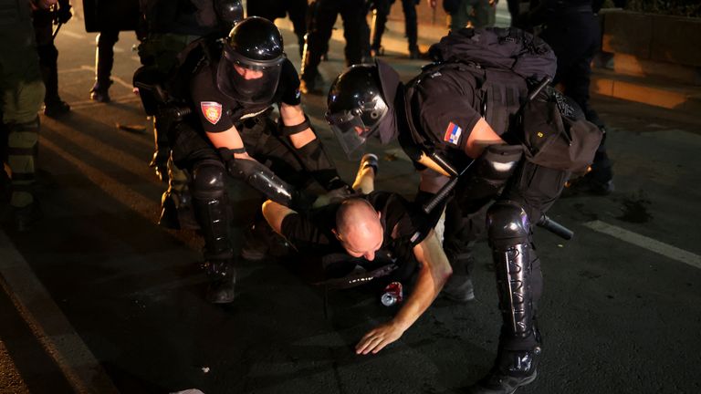 Law enforcement officers detain a demonstrator, during an anti-government protest. Pic: AP
