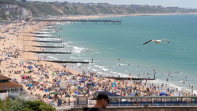İnsanlar Pazar günü Dorset'teki Bournemouth Plajı'ndaki sıcak havanın tadını çıkarıyor. Pic: PA