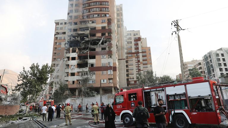 Firefighters work at the scene of a damaged building in the aftermath of Israeli strikes, in Tehran, Iran.
Pic: WANA/Reuters