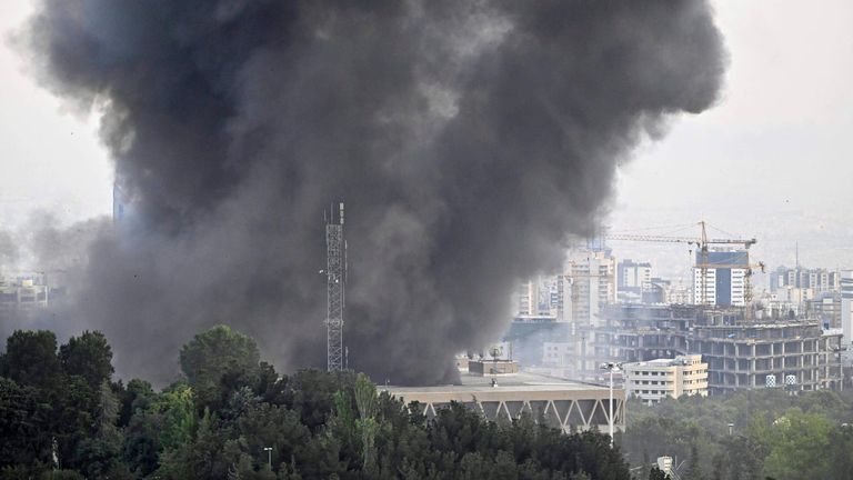 Black smoke billows from the headquarters of Iranian state television in Tehran. Pic: Kyodo via AP