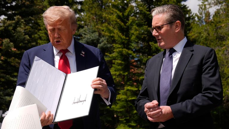 President Donald Trump drops papers as he meets with Britain's Prime Minister Keir Starmer in Kananaskis, Canada. Pic: AP