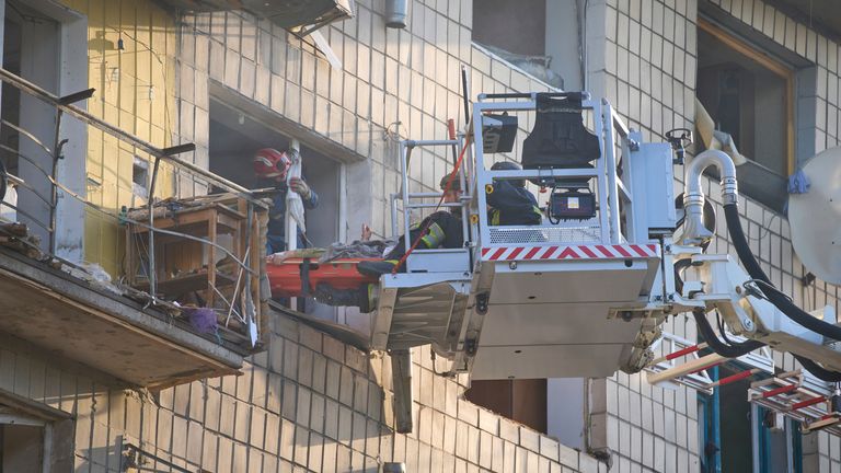 Emergency workers evacuate an injured resident following Russia's combined missile and drone attack in Kyiv, Ukraine, Tuesday, June 17, 2025