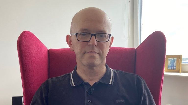  Chris Penfold-Ivany, a middle-aged bald white man with a black polo top and glasses sat in a chair, who spoke to Sky News