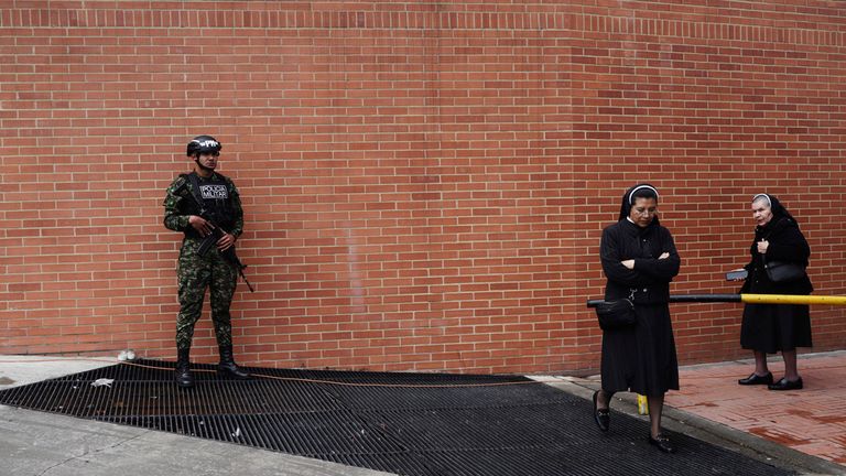 A soldier guards the clinic where Colombian Senator Miguel Uribe Turbay is being treated 