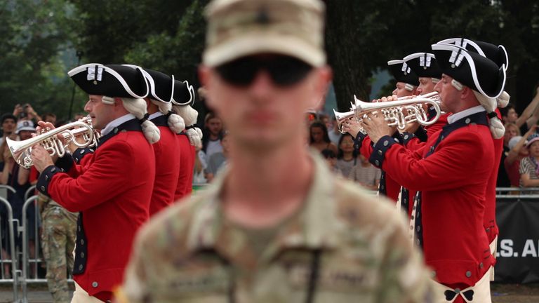 A period era brass band marches past playing trumpets. Pic: Reuters