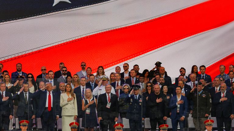 Donald Trump, Pete Hegseth and first lady Melania Trump gesture while they listen to the anthem. Pic: Reuters