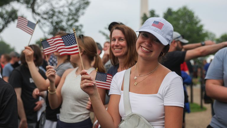 Bir seyirci bir Amerikan bayrağı sallar. Pic: AP