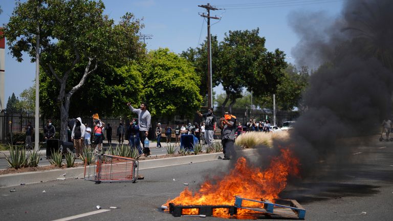 Fires amid immigration protests in Paramount, Los Angeles County on Saturday. Pic: AP