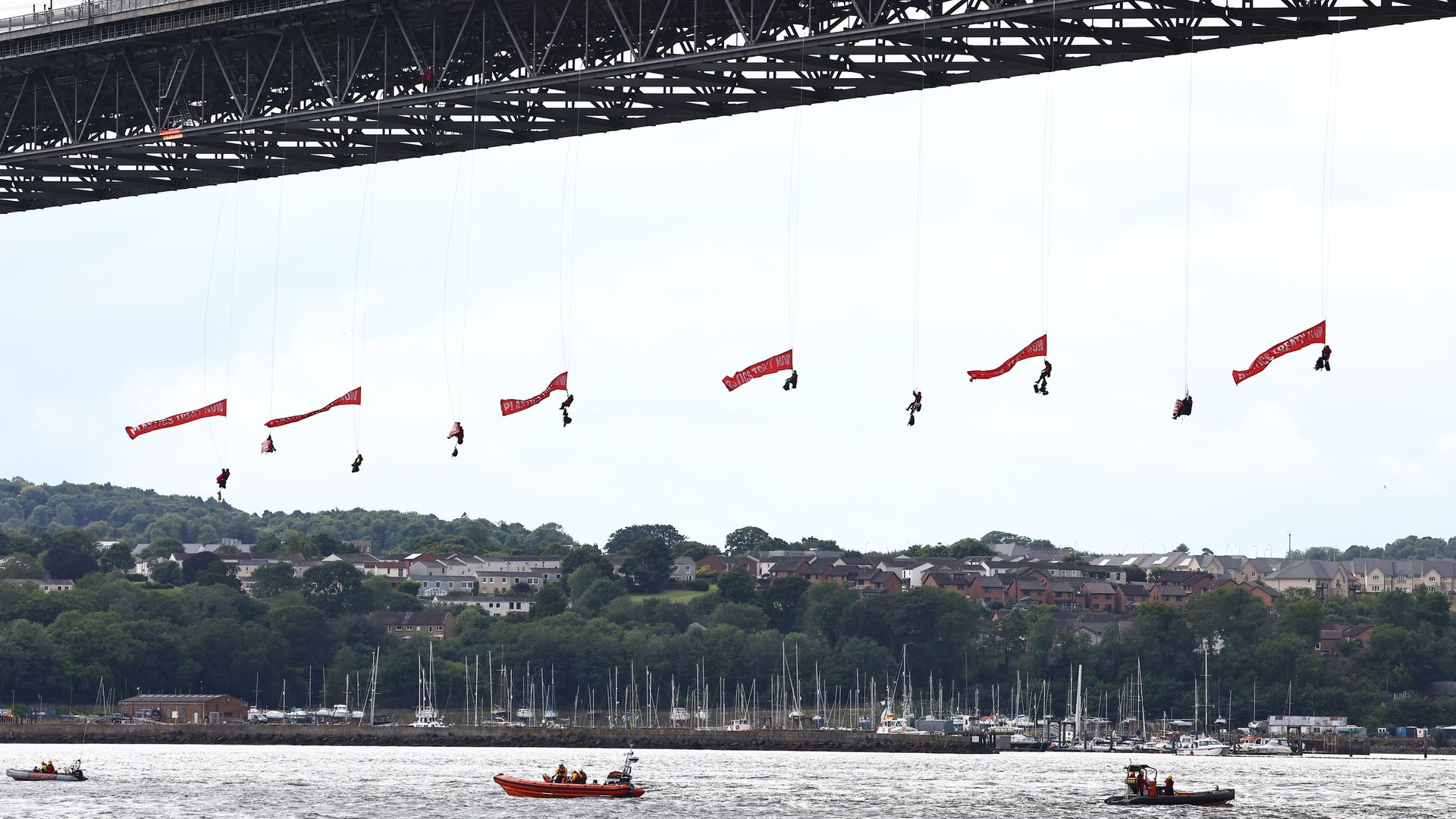 Ten Greenpeace activists arrested after suspending themselves from bridge