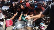 Palestinians gather to receive food from a charity kitchen, amid a hunger crisis, in Nuseirat, central Gaza Strip, July 20, 2025. REUTERS