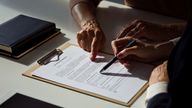 Female lawyer explaining the will to senior woman. Close up of hands, unrecognizable people. Pic: iStock

