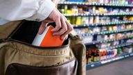 A man apparently stealing something from a shop. Pic: iStock