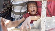 Palestinians wait to receive food from a charity kitchen, amid a hunger crisis, in Gaza City, July 24, 2025. REUTERS/Khamis Al-Rifi