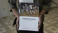 A copy of the report by the Dinah Project. Pic: AP/Maya Alleruzzo

