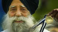 Singh shows off his medal from the Edinburgh Marathon in 2005. Pic: PA