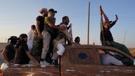 Bedouin fighters ride a truck in the village of Al-Mazraa, after days of violence in the Sweida province sparked by clashes between Bedouin 