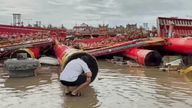 A  resident checks the collapsed temple structures submerged in floodwaters after Typhoon Danas landed in Tainan, Taiwan. 
Pic: TVBS/AP