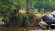 A man reacts while stopping on the road alongside Camp Mystic. Pic: AP/Julio Cortez