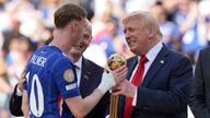 Mr Trump gives Cole Palmer the golden ball trophy. Pic: AP