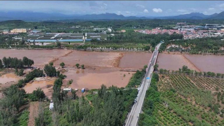 China orders 'all-out' rescue operation as 10 killed and dozens missing after floods