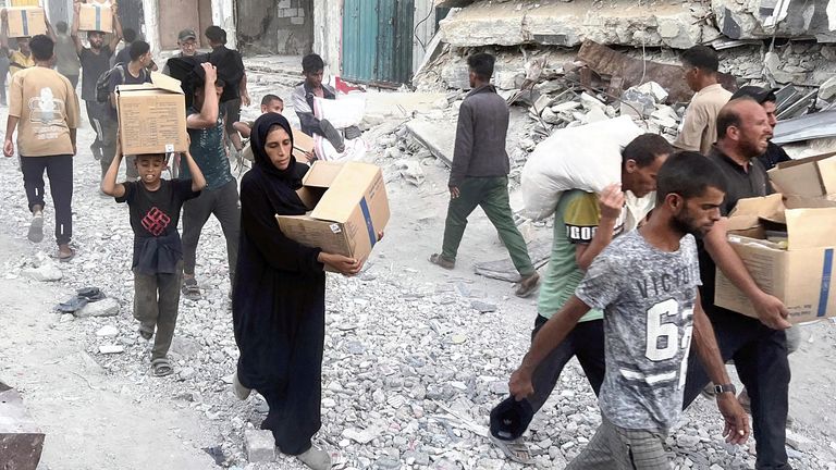People carry distributed aid supplies in Khan Yunis, southern Gaza, on July 1, 2025. Pic: AP