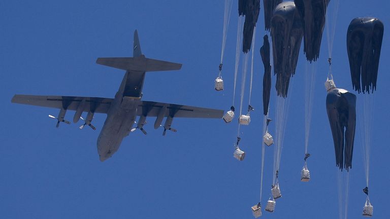 An aircraft drops humanitarian aid over Gaza on Sunday. Pic: Reuters