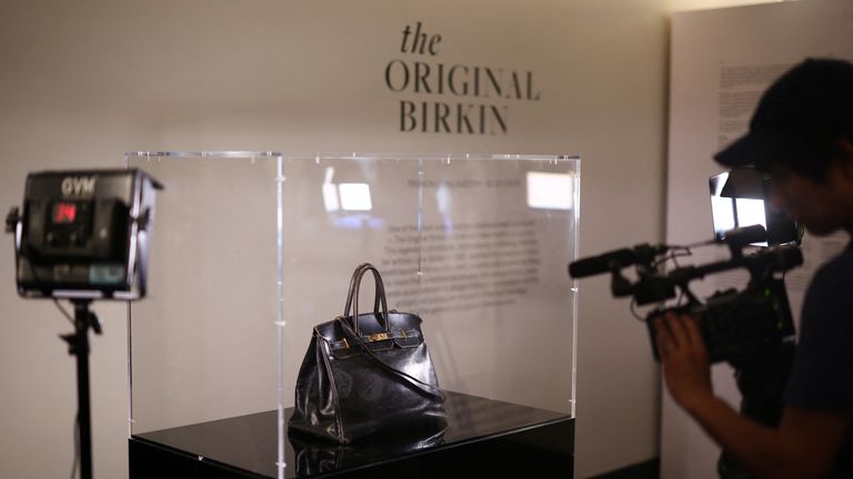 A cameraman films the Original Birkin, the handbag crafted by French luxury fashion house Hermes for artist Jane Birkin. Pic: Reuters