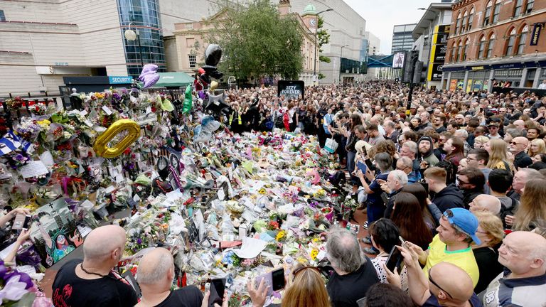 People gather around tributes at the Black Sabbath Bridge.
Pic: Reuters