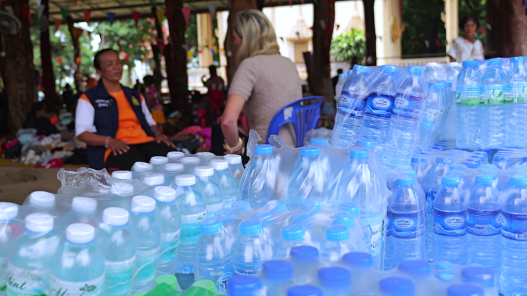 Water bottles in front of Ruehtairat Bula, speaking to Sky's Cordelia Lynch from Baan Nong Sanom Temple in Si Sa Ket province, Thailand