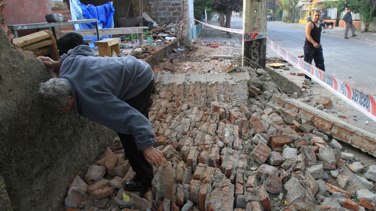 A man clears rubble after earthquake hits Chile on 27 February 2010. Pic: Reuters