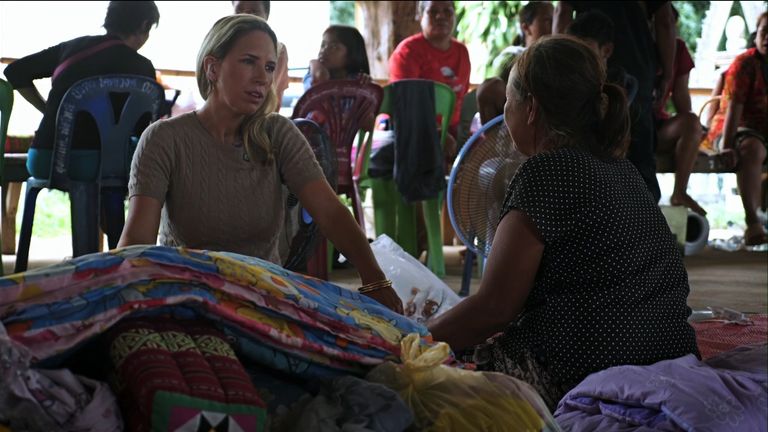Cordelia Lynch sits with a displaced woman in Thailand 