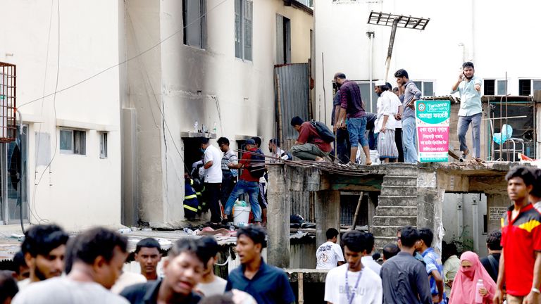 Firefighters and volunteers work after an air force training aircraft crashed into Milestone College campus, in Dhaka.
Pic: Reuters