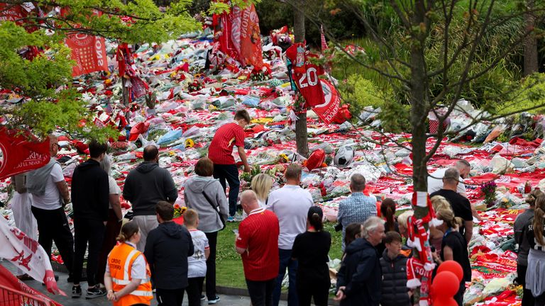 Fans pay their respects outside Anfield Stadium, on the day of the funeral of Liverpool soccer player Diogo Jota in Portugal, in Liverpool, 