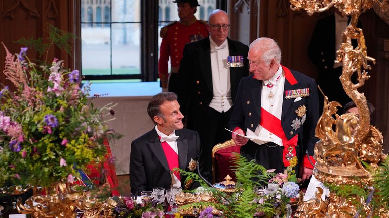 King Charles looks at Emmanuel Macron at a state banquet at Windsor Castle
