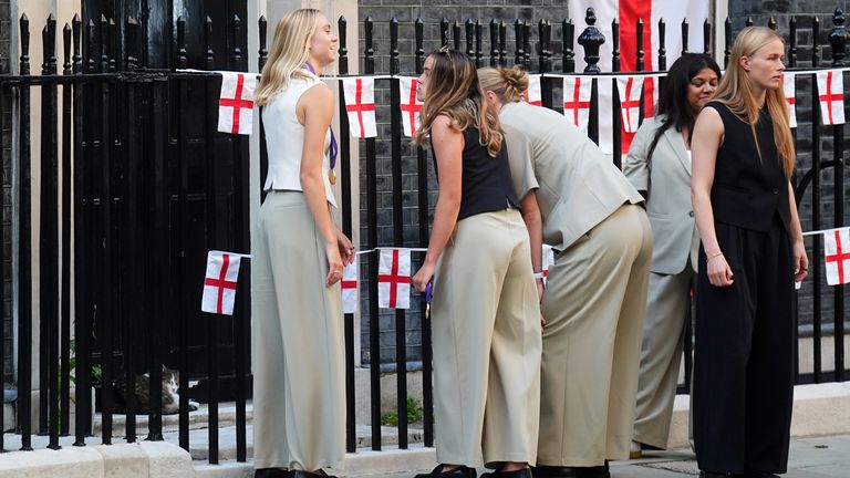 England's Esme Morgan, Anna Moorhouse and Grace Clinton try and get Larry the Cat's attention as they leave No.10 Downing Street. Pic: PA 