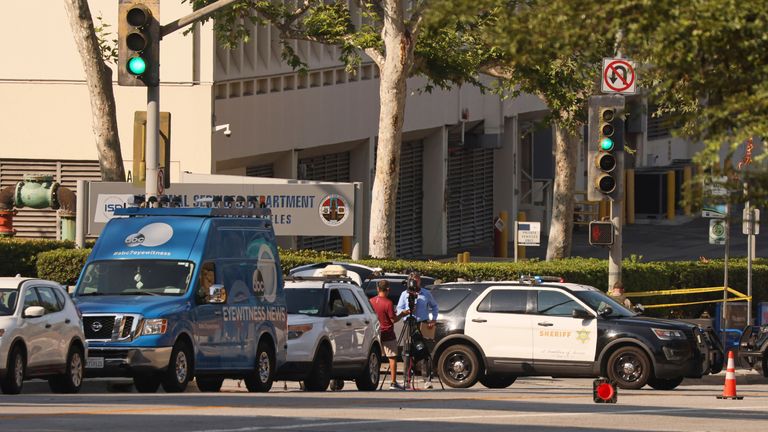 Media and law enforcement stage near the site of an explosion at the LA County Sheriff's Special Operations Bureau on Friday, July 18, 2025, in Los Angeles. (AP Photo/Etienne Laurent)