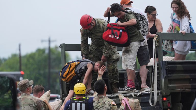 First responders deliver people to a reunification center after flash flooding in Ingram, Texas. Pic: AP