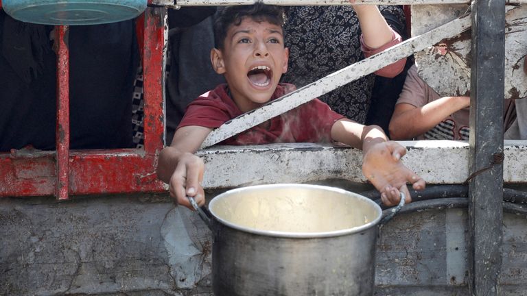 A Palestinian reacts as he waits to receive food from a charity kitchen in Gaza.
Pic Reuters