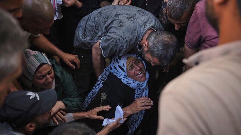 The mother of Anas Al-Basyouni mourns his loss shortly after he was killed while on his way to an aid distribution center, during his funeral at Shifa Hospital in Gaza City on Thursday, July 3, 2025. (AP Photo/Jehad Alshrafi)