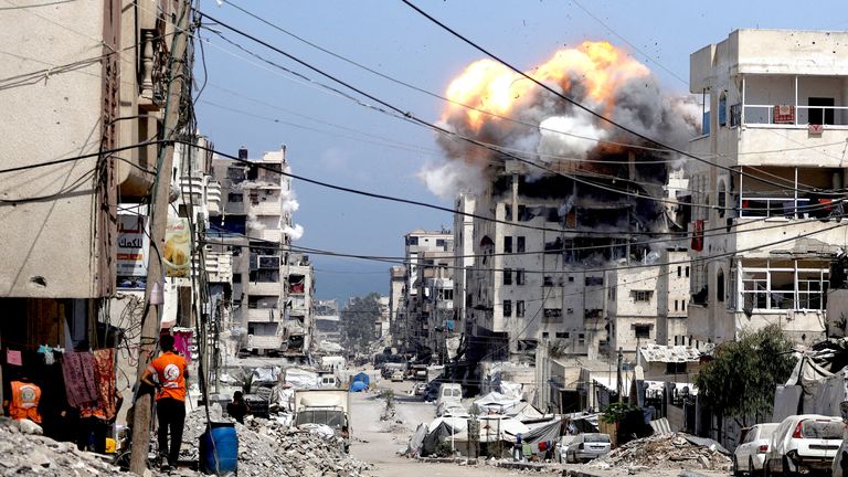 Smoke and flames rise from a residential building hit by an Israeli strike, in Gaza City July 21, 2025. REUTERS/Khamis Al-Rifi     TPX IMAGES OF THE DAY     