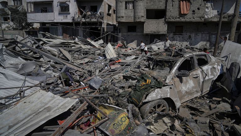 Palestinians inspect the wreckage of a gas station destroyed in an Israeli airstrike in Deir al-Balah, central Gaza Strip, Saturday, July 12, 2025. (AP Photo/Abdel Kareem Hana)