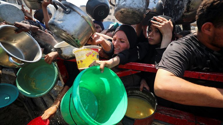 Palestinians gather to receive food from a charity kitchen, amid a hunger crisis, in Gaza City.
Pic: Reuters