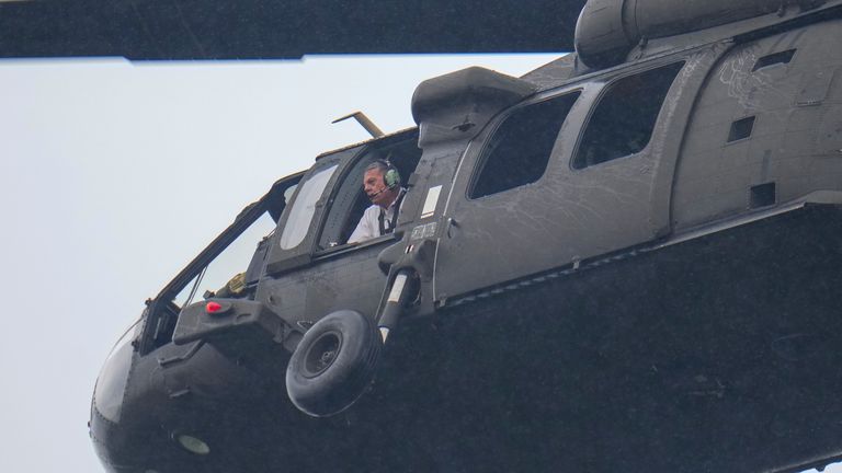 An official looks out a helicopter while flying over Camp Mystic along the banks of the Guadalupe River.
Pic: AP