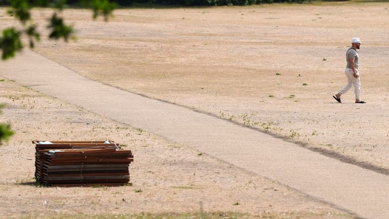 A person walks across the dry grass in Hyde Park.
Pic PA 