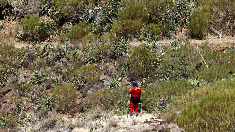 A volunteer firefighter searches for the young Briton Jay Slater in the Juan Lopez ravine near Masca, on the island of Tenerife, Spain, June