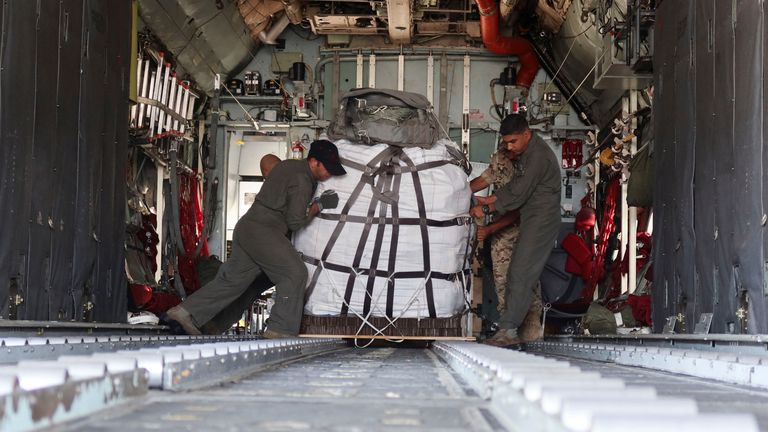Jordanian military personnel load aid parcels onto a plane that will be airdropped over Gaza, in Zarqa, Jordan.
Pic: Reuters