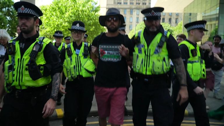 Police lead a protester away in Manchester