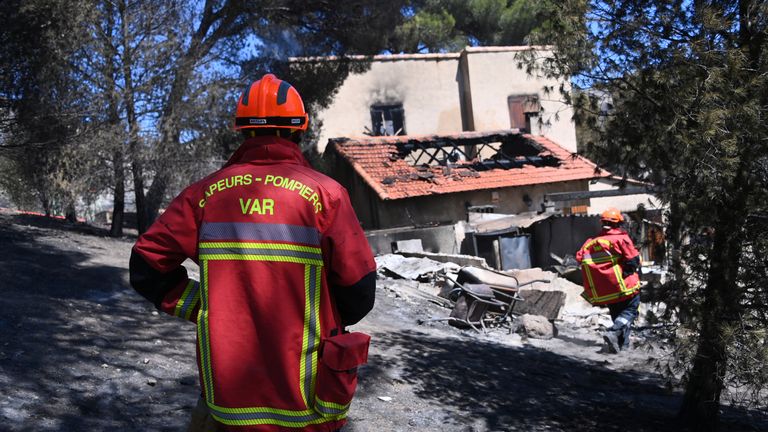French firefighters check a house destroyed by a wildfire in the L'Estaque district of Marseille, southern France, July 9, 2025. REUTERS